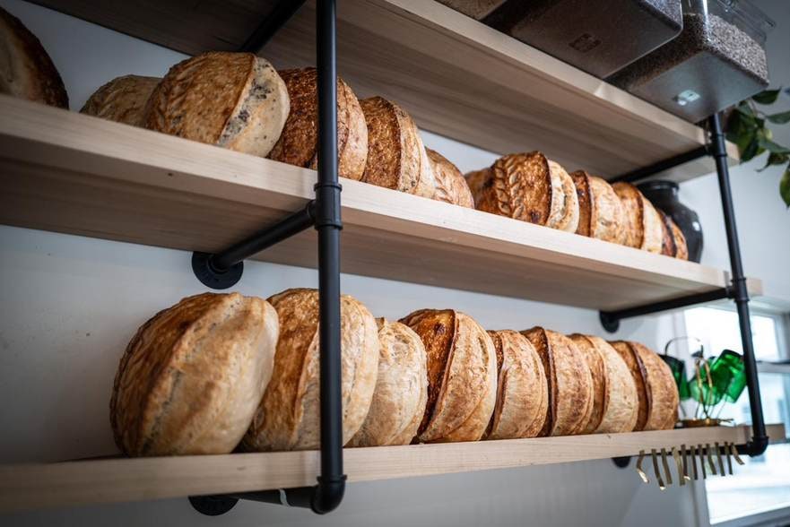Shelves lined with sourdough loaves